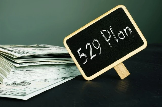 529 plan written on blackboard next to cash