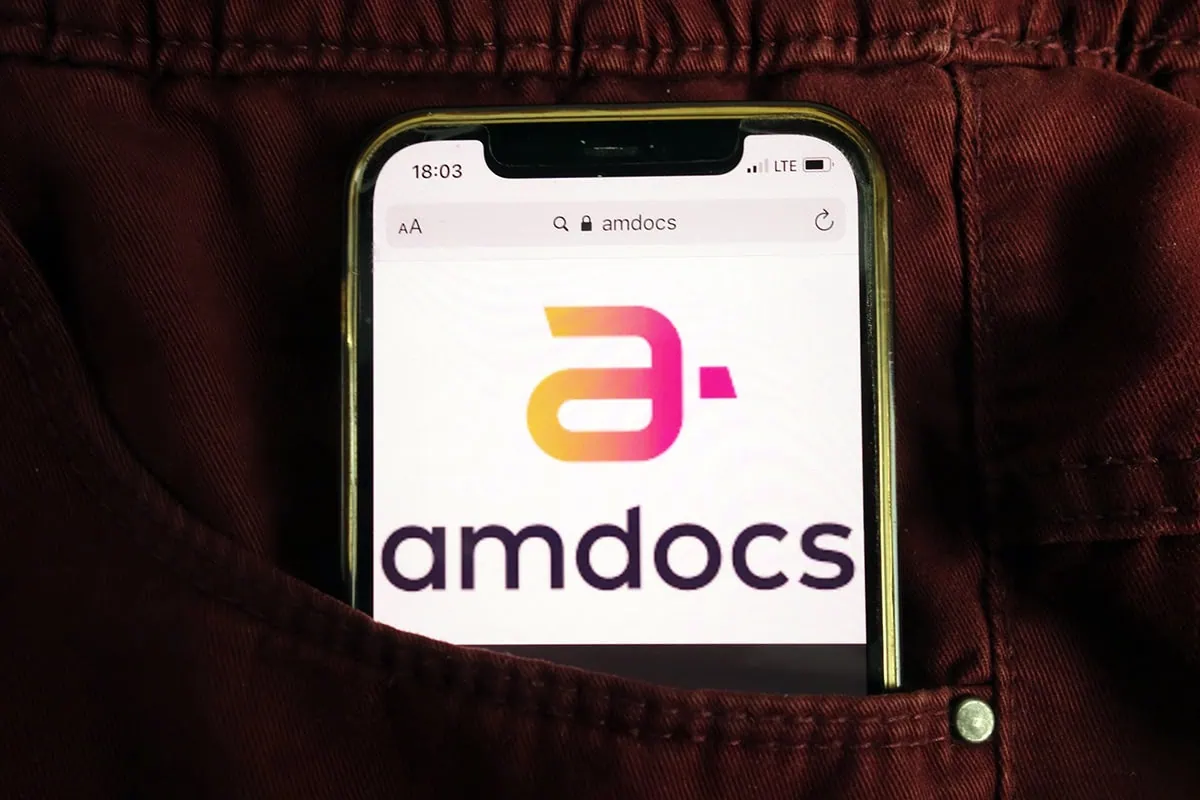 a cell phone in a back pocket that shows the amdocs logo.