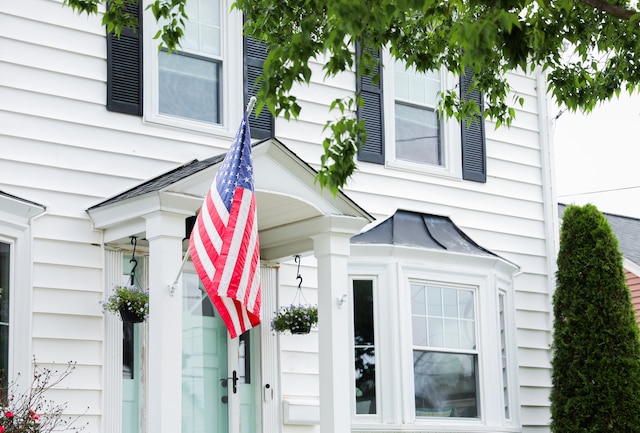 american flag hanging on front of house