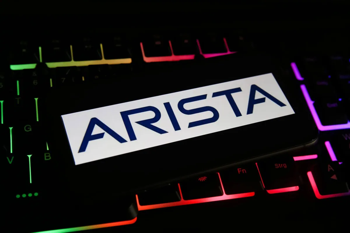 A darkly lit keyboard with the Arista Networks logo over it.