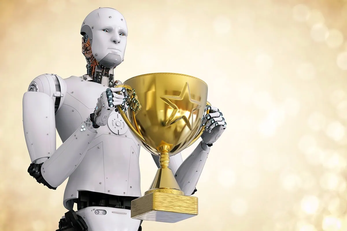 a humanoid robot holding a gold trophy.