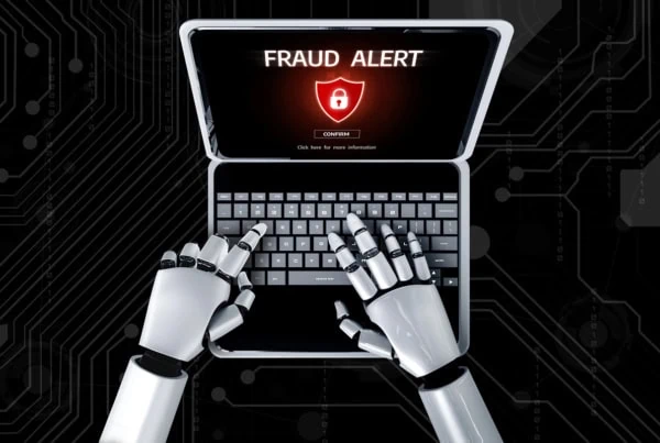 concept art of a robot using a laptop that says fraud alert on the screen.