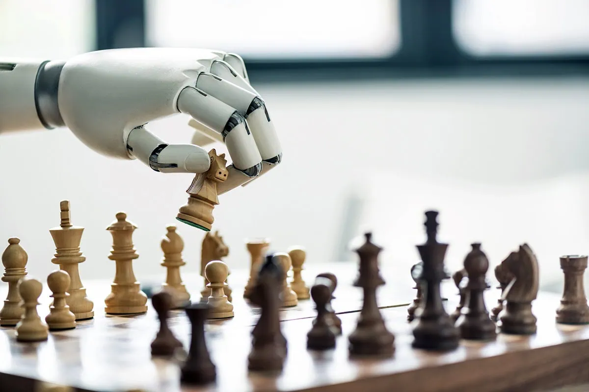a robot arm moves a knight piece in a game of chess.