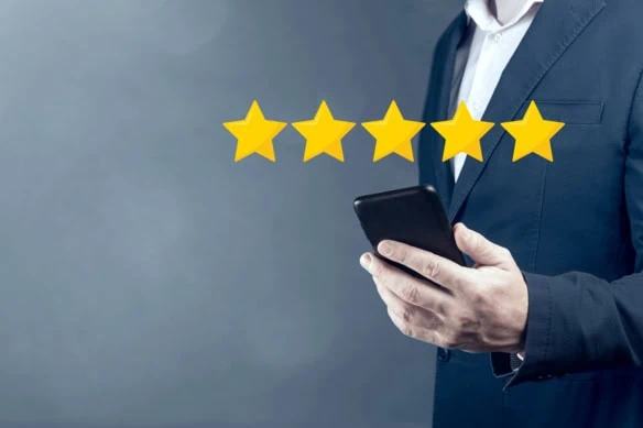 a man is looking at a phone while a five-star rating hovers over it.