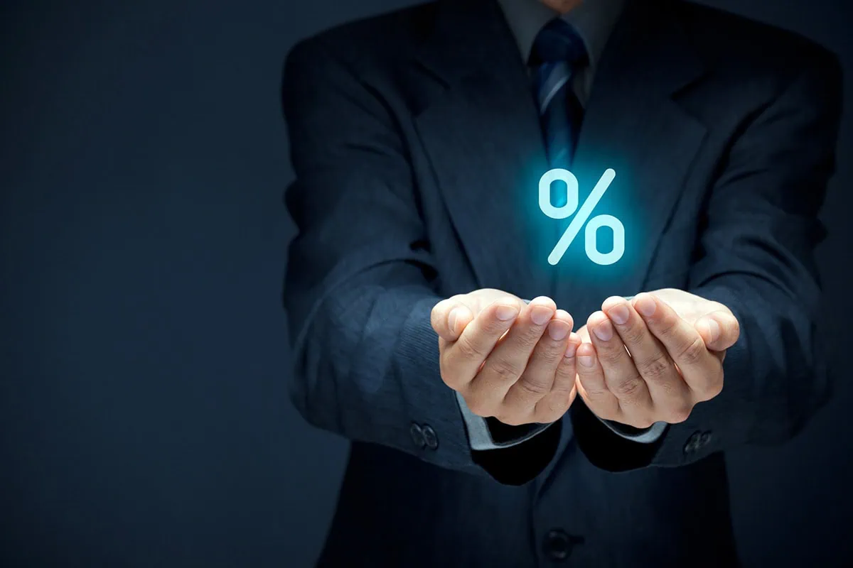 Preferred Stock ETFs: 3 Lesser-Known Ways to Earn 5.0%-6.3% 2 a businessperson cups his hands and a virtual percent sign floats above them.