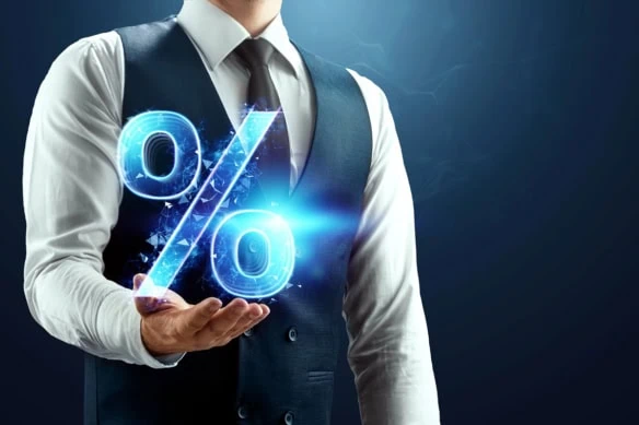 a businessman holds up a virtual percent sign.