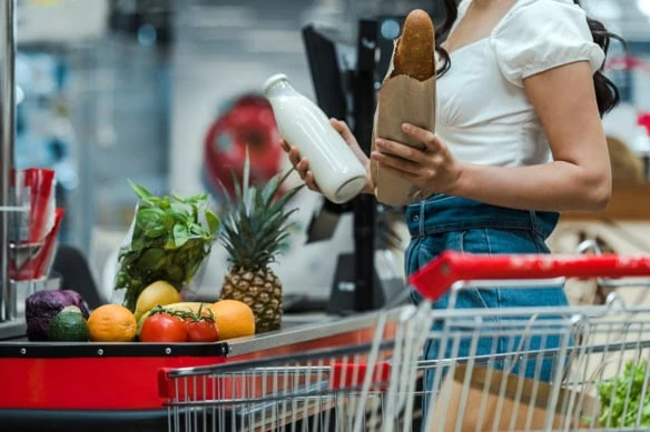 a person checks out at the grocery counter.
