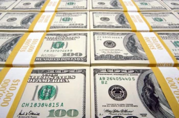stacks of dollar bills with a yellow ribbon.
