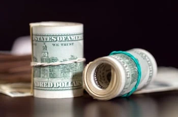 two rolls of hundred dollar bills.