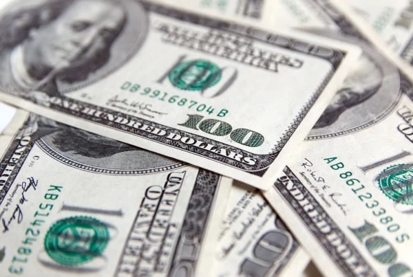 a closeup of a pile of hundred dollar bills.