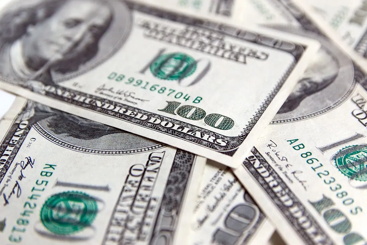 a closeup of a pile of hundred dollar bills.