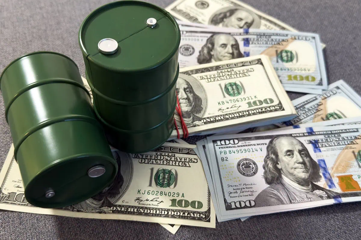 Will Oil Spike Again? If So, These 5 Energy ETFs Could Get Hot Again 3 barrels of oil sitting atop stacks of cash.