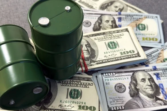 barrels of oil sitting atop stacks of cash.