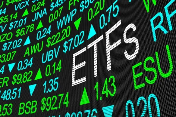 a stock tickerboard with the word ETFs spelled out in larger lettering than the rest.