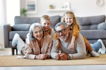 a cheerful family of grandparents and young children.