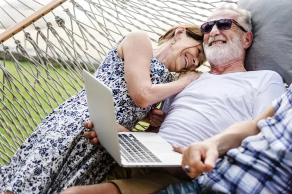 Lovely mature couple resting on a hammock while on vacation.