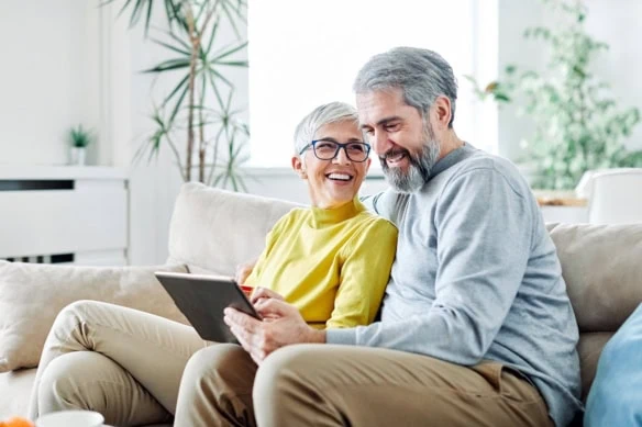 a happy senior couple looking at a tablet computer.