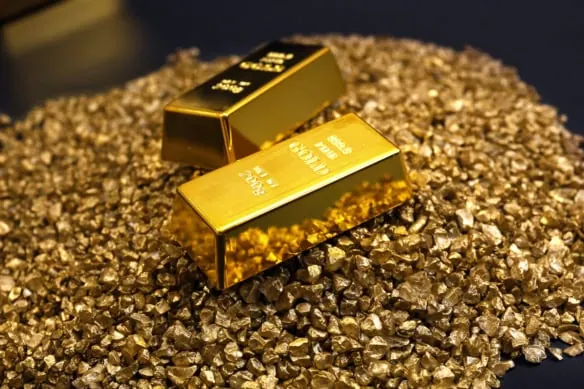 gold bars sit on top of gold nuggets.