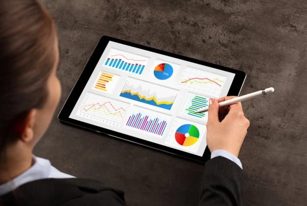 a fund manager looks over a fund report on a tablet computer.