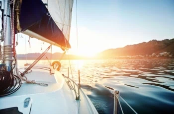 a sailboat on calm lake water.