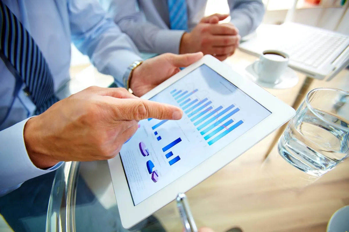 The Bat Mitzvah Gift Guide: Financial Presents to Set Her Up for Future Success 3 a fund manager looks at a set of charts for a mutual fund.