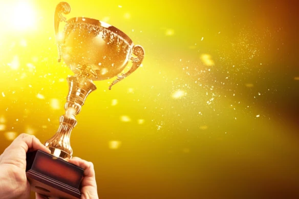 a gold trophy against a yellow background.