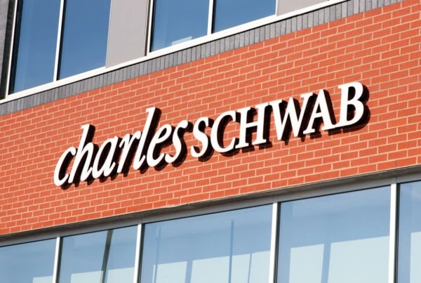 a charles schwab sign on a brick building.