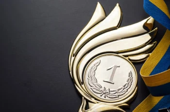 a gold medal with wings.