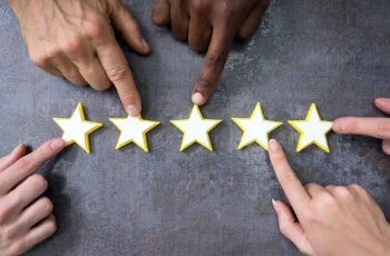 many hands pointing to a five star rating.