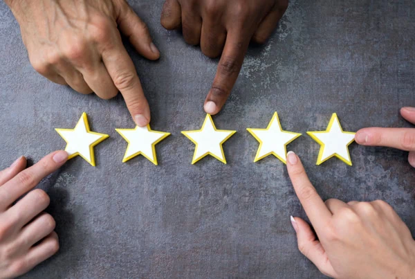 many hands pointing to a five star rating.