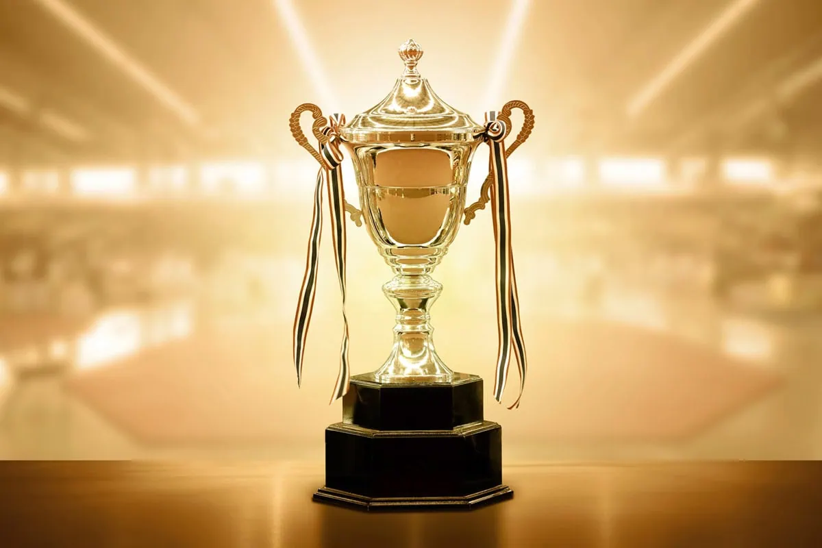 a gold trophy with a shiny gold background.