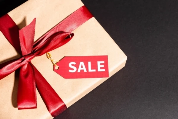 a gift box with a sale sign on it.