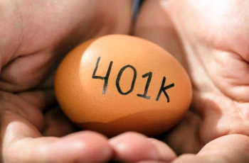a person holding a brown egg that says 401k.