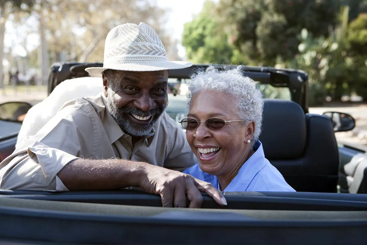 Retirement Refresh: 10 Life Upgrades That Go Beyond Home Renovations 5 Portrait of senior couple at the back seat of their car smiling.