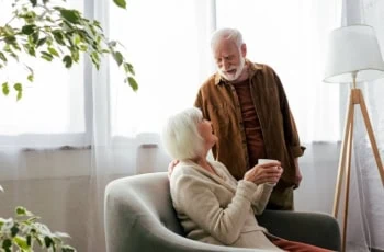 a senior couple looks at each other lovingly.