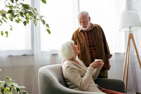 a senior couple looks at each other lovingly.