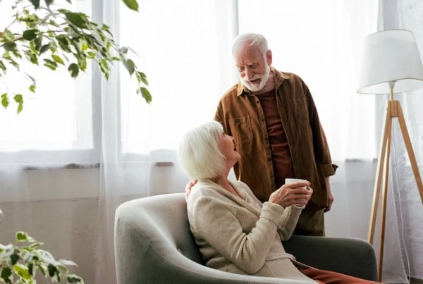 a senior couple looks at each other lovingly.