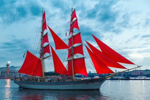 Swedish brig Tre Krunur a ship with big red flags resembling the vanguard logo.