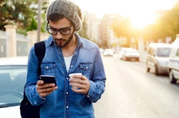 better money habits man mobile phone coffee 1200