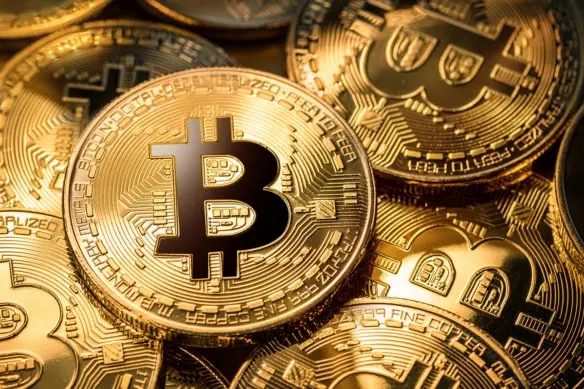 gold bitcoin coins on a gold background.