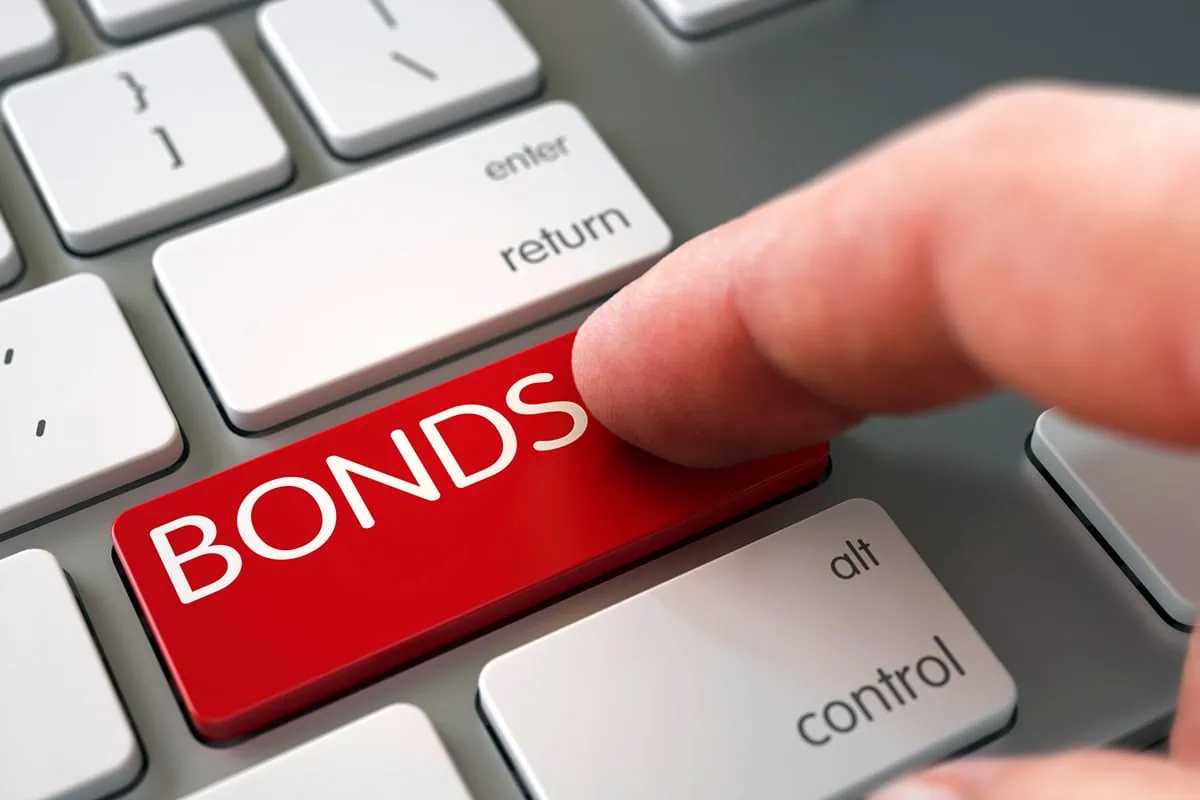 a person pushes a red keyboard button that says bonds.