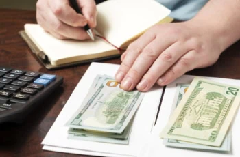 budgeting 50 30 20 notebook dollar bills 1200