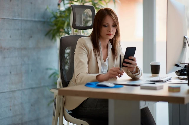 businesswoman office smartphone app investing