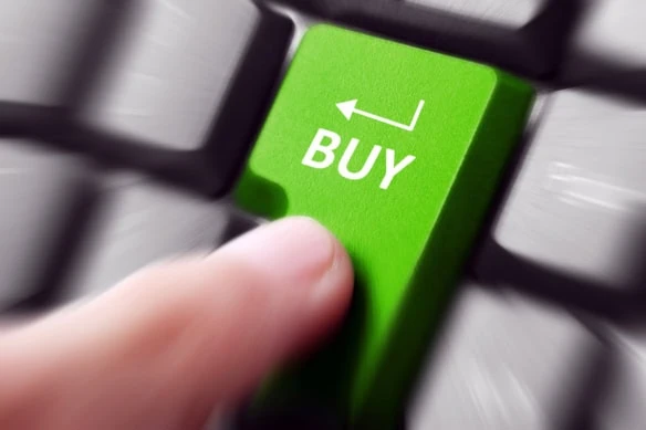 a person presses a keyboard button that says buy.