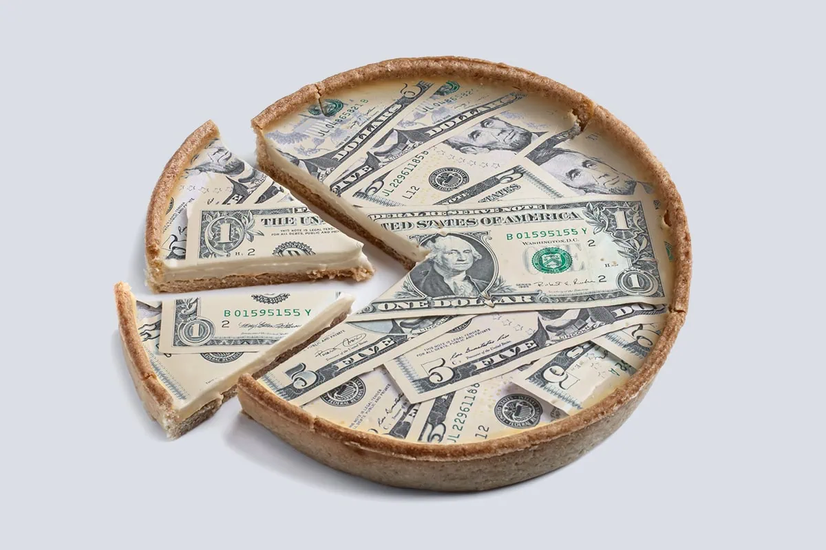 a pie made out of dollar bills with two slices cut out.