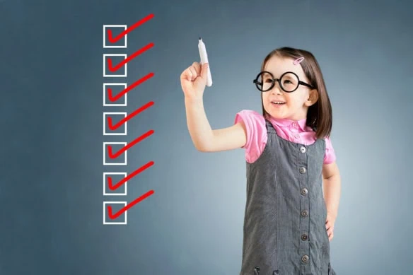Concept art of a girl crossing off checkmarks on a chalkboard.