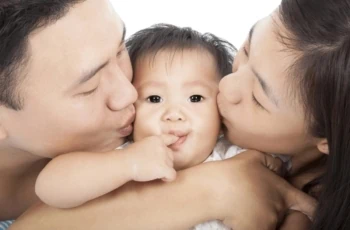 child tax credit parents kissing baby