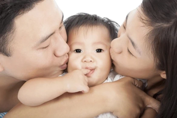 child tax credit parents kissing baby