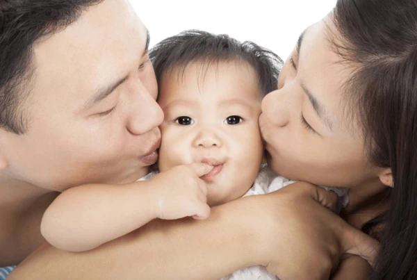 child tax credit parents kissing baby