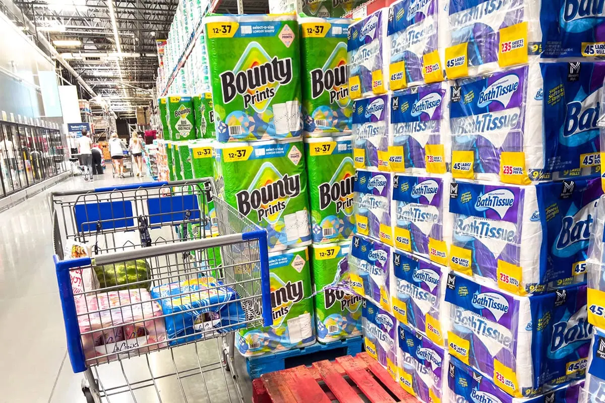 These 3 Consumer Staples Funds Deliver Safety and Income 6 a grocery cart sits near packaged toilet paper and paper towels.